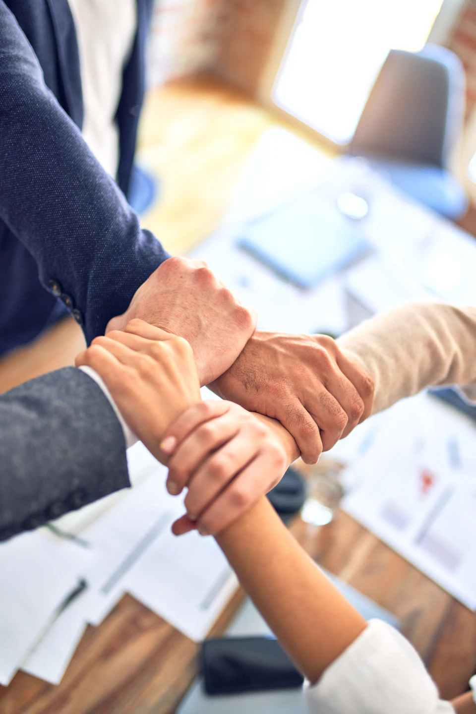 Colleagues joining hands